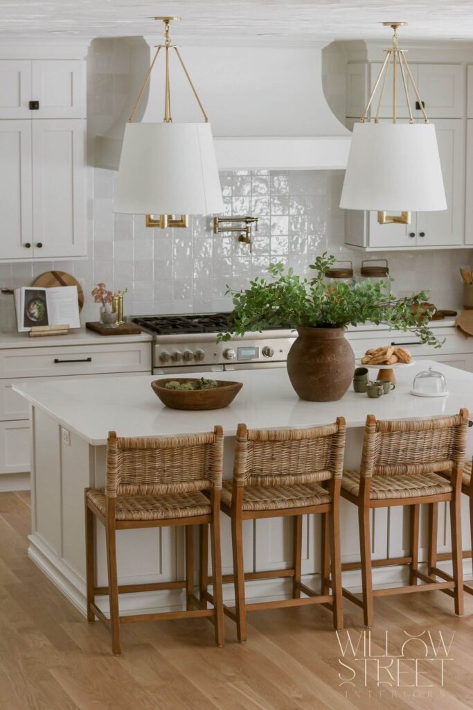 bright and airy white kitchen with zellige tile timeless brass fixtures and layered organic textures designed by interior design firm willow street interiors in Massachusetts