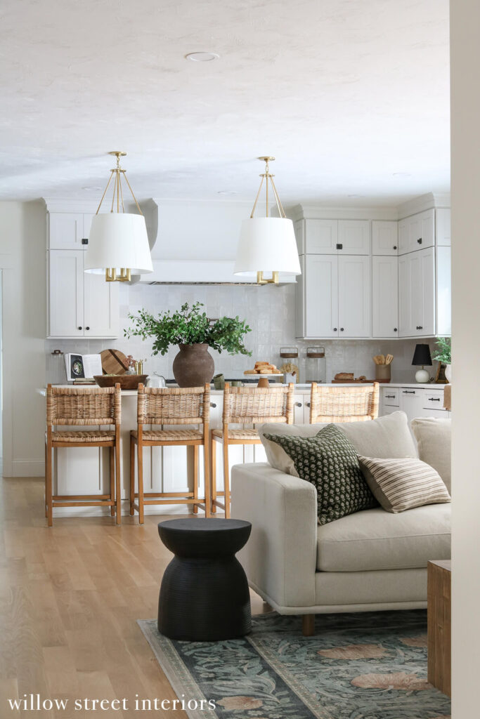 bright and airy white kitchen with zellige tile timeless brass fixtures and layered organic textures designed by interior design firm willow street interiors in Massachusetts