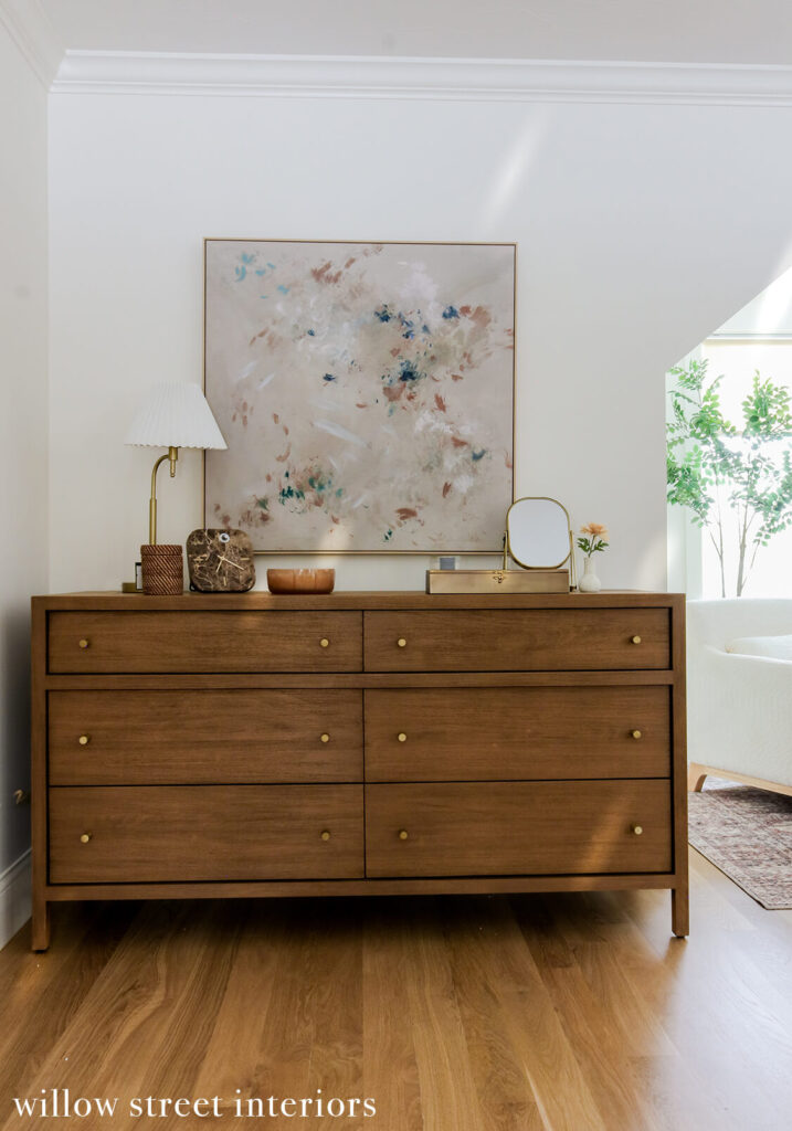 Layered neutral-toned master bedroom with upholstered headboard and wood nightstands, designed by Massachusetts interior design studio”